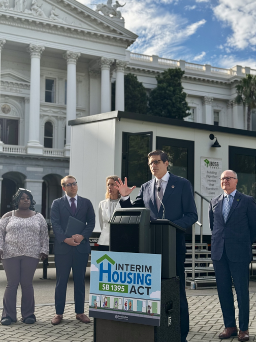 Senator Becker holding a press conference on SB 1395 with Senator Catherine Blakespear and Assemblymember Gregg Hart, while showcasing affordable, and dignified interim housing units.