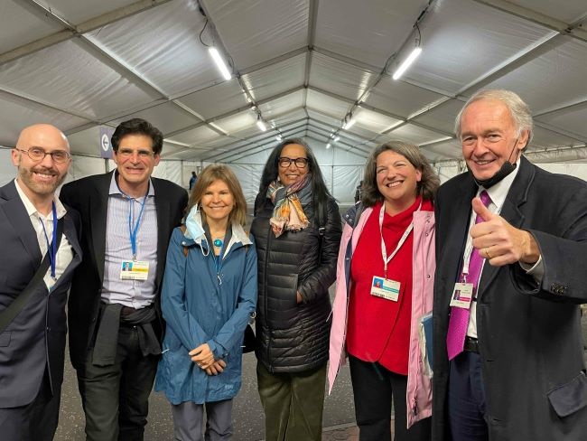 Photo of Mark Carrato, Power Africa Coordinator for the USAID Foreign Service Office, Senator Becker, Indiana State Representative Carey Hamilton, Colorado State Representative Dominique Jackson, Rhode Island State Senator Dawn Euer, and US Senator Ed Markey of Massachusetts at COP26..