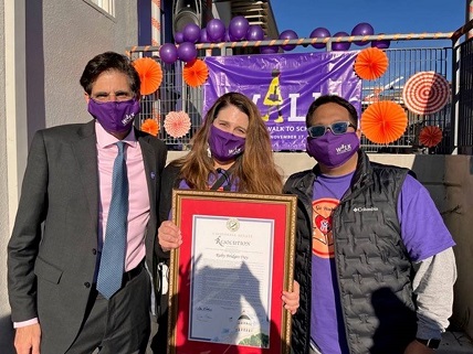 Senator Josh Becker, Martin Elementary School teacher Deborah Carlino and Principal Jonathan Covacha with the proclamation presented by the senator to declare Ruby Bridges Walk to School Day in California.