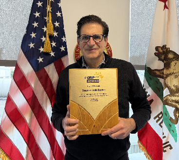 Senator Becker holding his Trailblazer Award from GRIP